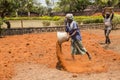 Indian men at work with seal to move the orange earth to cultivate food vegetables grass