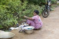 Indian poor woman wash clothes in street rural village