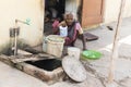 Indian poor woman wash clothes in street rural village