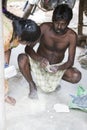 Unidentified indian worker artisan carving Hindu gods and saints from granite.