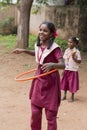 Documentary editorial image. Young child plays With Hula Hoop In Summer Field, in school