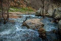 Ponsul river flowing through huge stones during the daytime