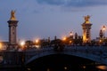 Pont Alexandre III Bridge and illuminated lamp posts at sunset. 7th Arrondissement, Paris, France Royalty Free Stock Photo