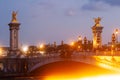 Pont Alexandre III Bridge and illuminated lamp posts at sunset. 7th Arrondissement, Paris, France Royalty Free Stock Photo