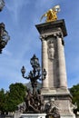 Pont Alexandre III detail, column with gilded sculpture and bronze street light. Paris, France. Royalty Free Stock Photo