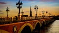 Pont de Pierre bridge and motion blur of tram in Bordeaux at sunset as the night sky scene Royalty Free Stock Photo