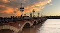 The Pont de pierre at sunset in the famous winery region Bordeaux, France Royalty Free Stock Photo