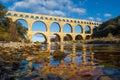 The Pont du Gard viewed from the river. Ancient Roman aqueduct bridge. Photography taken in Provence, southern France Royalty Free Stock Photo