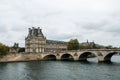 Pont Royal bridge over the river Seine with the Pavillon de Flore in the background on a cloudy day Royalty Free Stock Photo