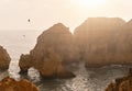 Ponta da Piedade headland with group of rock formations textures background yellow-golden cliffs along limestone coastline, Lagos