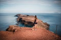 Ponta De Sao Lourenco at Madeira Islands - Portugal, Beautiful woman standing against view. View of rocks, beach, cliffs and mount