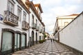 Ponta Delgada, Azores, Portugal - Jan 12, 2020: Cobbled street in the historical center of the Portuguese city. Traditional houses Royalty Free Stock Photo