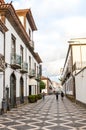 Ponta Delgada, Azores, Portugal - Jan 12, 2020: Cobbled street in the historical center of the Portuguese city. Traditional houses Royalty Free Stock Photo