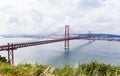 Ponte 25 de Abril Bridge in Lisbon, Portugal. Connects the cities of Lisbon and Almada crossing the Tagus River. View from Almada Royalty Free Stock Photo