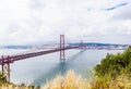 Ponte 25 de Abril Bridge in Lisbon, Portugal. Connects the cities of Lisbon and Almada crossing the Tagus River. View from Almada Royalty Free Stock Photo