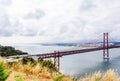 Ponte 25 de Abril Bridge in Lisbon, Portugal. Connects the cities of Lisbon and Almada crossing the Tagus River. View from Almada Royalty Free Stock Photo