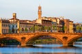 The Ponte Santa Trinita over Arno river at sunset, seen from the attractive promenade Lungarno Guicciardini in Florence. .