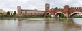 Ponte  Scaligero bridge, Castelvecchio castle and the area adjacent to them. View from the left bank of Adige river in Verona, Royalty Free Stock Photo