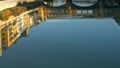 Ponte Vecchio bridge and Florentine houses reflection on water, Florence, Italy