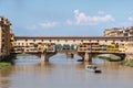 Ponte Vecchio bridge over the Arno river with a touristic boat daytime photo in old Florence city, Toscana, Italy. Old Royalty Free Stock Photo