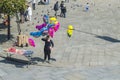 A young Gypsy girl sells colored balloons