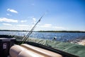 Pontoon boat with fishing poles on a lake on a sunny day Royalty Free Stock Photo