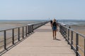 Pontoon Pier of Andernos les Bains France with young woman walking behind