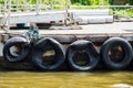 Pontoon with recycled old tyres used as boat bumpers. Royalty Free Stock Photo