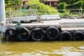 Pontoon with recycled old tyres used as boat bumpers.