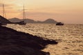 Ponza Island, Italy - 27 July 2019: Sunset on little harbor of Ponza island in the summer season with boats and cliffs silhouette Royalty Free Stock Photo