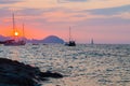 Ponza Island, Italy - 27 July 2019: Sunset on little harbor of Ponza island in the summer season with boats and cliffs silhouette Royalty Free Stock Photo