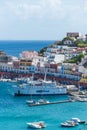 The port of the Ponza island in summer. Coloured houses, boats, ferry in the harbour of island of Ponza.