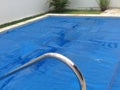 Pool in backyard with a thermal cover