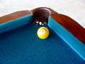 Pool ball near the hole of the table Royalty Free Stock Photo