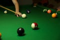 Pool balls and billiard cue on green billiard table Royalty Free Stock Photo