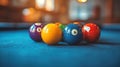 Pool balls clustered on a blue table Royalty Free Stock Photo