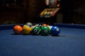 Pool balls over a blue table prepared for the game. Royalty Free Stock Photo