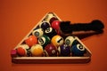 Pool balls pyramid on orange cloth for eightball game