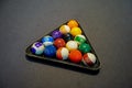 Pool billiard balls in a wooden rack on black background Royalty Free Stock Photo