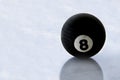 Pool black ball number eight on ice surface Royalty Free Stock Photo