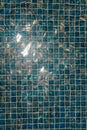 A pool with blue ceramic tiles and water ripple effect. Refection of Blue water in Swimming pool with Ripple. close-up Royalty Free Stock Photo