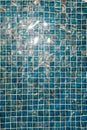A pool with blue ceramic tiles and water ripple effect. Refection of Blue water in Swimming pool with Ripple. close-up Royalty Free Stock Photo