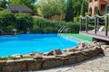 Pool with blue water near the house in the summer