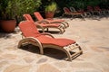 Pool chaise loungers on a patio in the sunshine at a resort Royalty Free Stock Photo