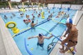 Pool with children and parents in the water playing. Family fun Royalty Free Stock Photo