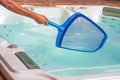 Hotel staff worker cleaning the pool. Maintenance