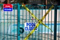 Pool closed sign on the entrance door to the pool area