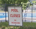 Pool Closed Sign on Fence Around Public Pool