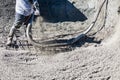 Pool Construction Worker Shooting Concrete, Shotcrete or Gunite Through Hose