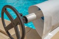 Pool cover on the edge of a pool during the summer Royalty Free Stock Photo
